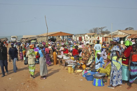 GAMBIA, Western Gambia , Tanji, Tanji market.  Busy market scene with line of food stalls and