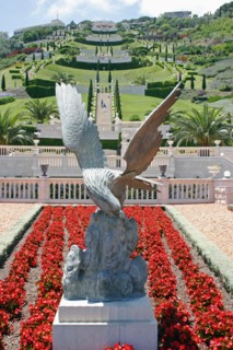 ISRAEL, Northern Coast, Haifa, Zionism Avenue.  Eagle sculpture set in flower bed of scarlet plants