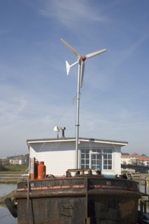 ENGLAND, West Sussex, Shoreham-by-Sea, "Houseboat, with large wind turbine in the deck, moored