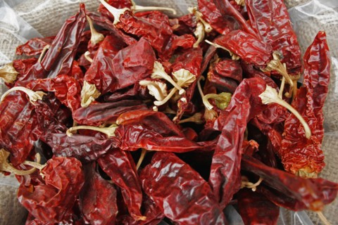 ISRAEL, Jerusalem, "Jerusalem food market.  Open sack of dried, red, hot chili peppers, close
