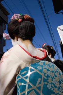 JAPAN, Honshu, Kyoto, Gion District.  Back of Geisha wearing pale pink silk kimono with turquoise