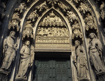 GERMANY, North Rhine Westphalia, Cologne, Cathedral doorway flanked by stone statues and decorative