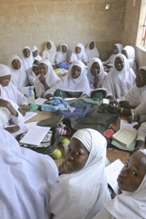 GAMBIA, Western Gambia, Tanji, Tanji Village.  African Muslim girls wearing white headscarves while