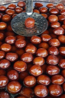 INDIA, Rajasthan, Udaipur, "Indian fried, sweet doughnuts in cooking pot of oil and syrup with