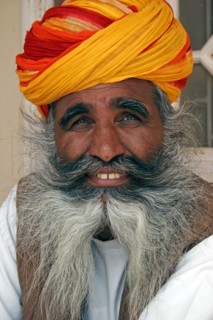INDIA, Rajasthan, Jodhpur, "Meherangarh Fort.  Head and shoulders portrait of a smiling Indian man