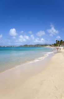 WEST INDIES, St Lucia, Gros Islet, Reduit Beach in Rodney Bay with tourists in the water and on the
