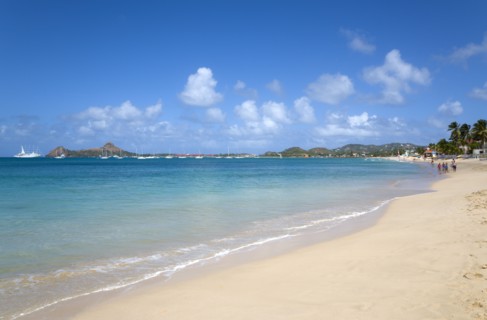 WEST INDIES, St Lucia, Gros Islet, Reduit Beach in Rodney Bay with tourists in the water and on the