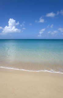 WEST INDIES, St Lucia, Gros Islet, View out to sea from Reduit Beach in Rodney Bay with a yacht