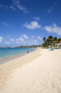 WEST INDIES, St Lucia, Gros Islet, Reduit Beach in Rodney Bay with tourists in the water and on the