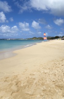 WEST INDIES, St Lucia, Gros Islet, Reduit Beach in Rodney Bay with tourists in the water and on the