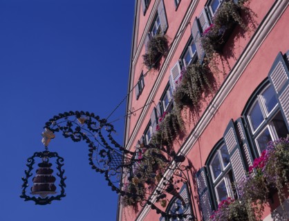 GERMANY, Bavaria, Dinkelsbuhl, Wrought iron cake sign for Cafe Rossimi attached to building facade
