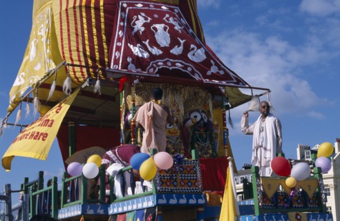 ENGLAND, East Sussex, Brighton, Hare Krishna taking part in a parade on Brighton seafront  with a