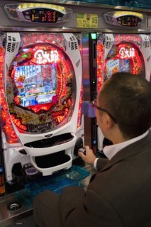 JAPAN, Honshu, Tokyo, Shinjuku.  Japanese man gambling at electronic machine