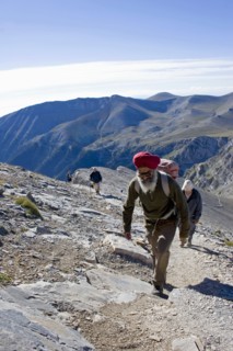 GREECE, Macedonia, Pieria, Olympus.  Group of four climbing steep slope of Mount  Olympus towards