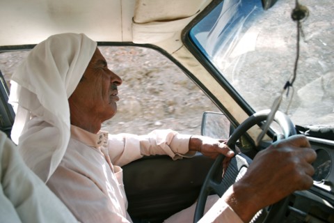 EGYPT, Sinai Desert, Ras el Satan, "Bedouin taxi driver wearing traditional Arabic dress of