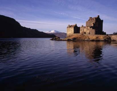 SCOTLAND, North West Highlands, Loch Duich, Eilean Donan Castle.  View of restored castle reflected