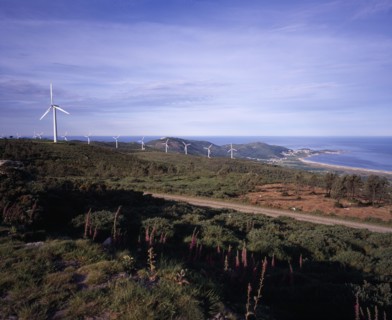 SPAIN, Galicia, Praia de Carnota, "Coastal landscape with line of wind powered electricity