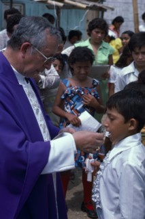 ECUADOR, Guayas Province, Guayaquil , Roman Catholic Bishop giving Communion in Barrio Indio Guayas