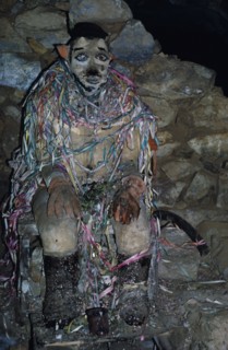 BOLIVIA, Potosi, Llallagua, Siglo XX  Tin Mine. Tio The God Who Protects the Miners. Miners give