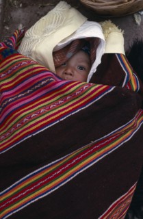 BOLIVIA, Potosi, Aymara baby wrapped in local poncho