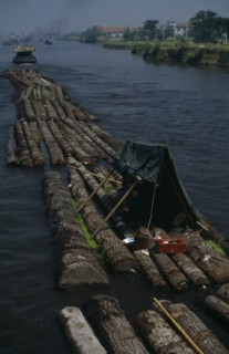 CHINA, Jiangsu Province, Transport, Log rafts on the Grand Canal between Suzhou and Wuxi. Men