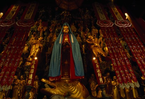 CHINA, Shanghai, Jade Buddha Temple interior with statue of standing Buddha draped in silk cloak
