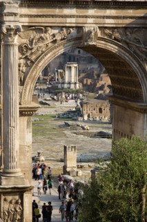 ITALY, Lazio, Rome, Tourists walking in the Forum with the Temple of The Vestals seen through the