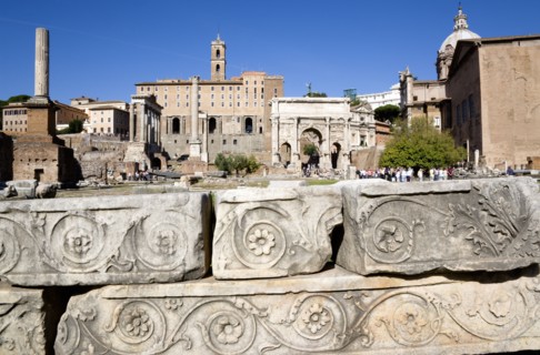 ITALY, Lazio, Rome, The Forum with tourists. Details of ruin fragments with the Arch of Septimius