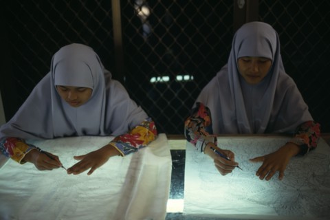 MALAYSIA, Crafts, Young women tracing floral patterns first on to paper then transferring them to