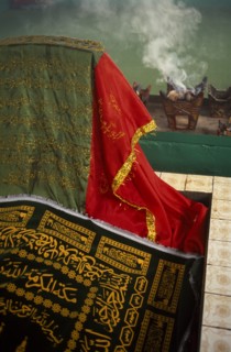 OMAN, Dhofar hills, Beit Zarbij, Frankincense burning in tomb of the prophet Job. Near Salalah.