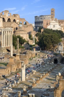 ITALY, Lazio, Rome, View of the Forum with the Colosseum rising behind the bell tower of the church