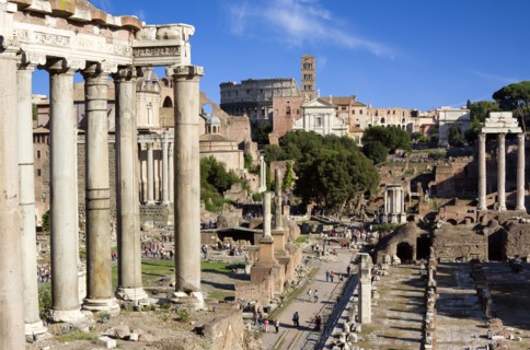 ITALY, Lazio, Rome, The Forum with the Colosseum rising behind the bell tower of Santa Francesca