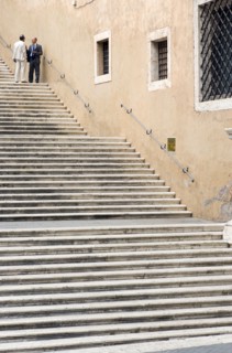 ITALY, Lazio, Rome, Two men talking in conversation on steps beside the Palazzo dei Conservatori on