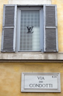 ITALY, Lazio, Rome, Road sign for the Via dei Condotti on the wall of the Louis Vuiton shop in the