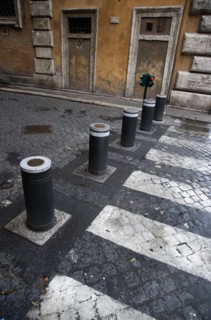 ITALY, Lazio, Rome, Automatic rising bollards and a pedestrian crossing in a side street with red