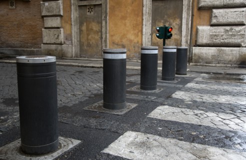 ITALY, Lazio, Rome, Automatic rising bollards and a pedestrian crossing in a side street with red