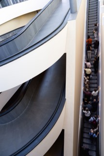 ITALY, Lazio, Rome, Vatican City Spiral ramp and escalator moving up with visitors at the entrance