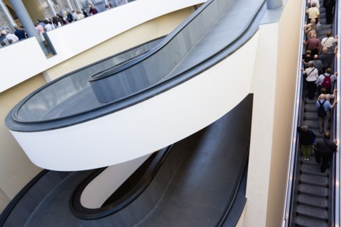 ITALY, Lazio, Rome, Vatican City Spiral ramp and escalator moving up with visitors at the entrance