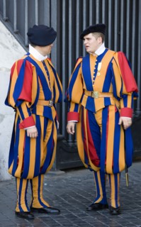 ITALY, Lazio, Rome, Vatican City Two Swiss Guards in full ceremonial uniform dress in conversation