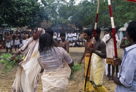 SRI LANKA, Religion, Hinduism, Punnaccolai Festival. Priest and woman in a state of trance watched