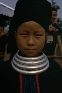 LAOS, Tribal People, Meo Tribe, Head and shoulders portrait of a Meo girl wearing traditional dress
