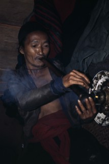 LAOS, Tribal People, Meo Tribe, Meo man smoking Opium