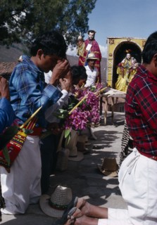 GUATEMALA, El Quiche, San Andres de Sajcabaja, Quiche Indian men knelling in prayer to the saints