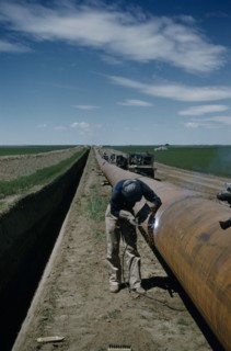 CANADA, Saskatchewan , Prairies, Constructing Trans Canada gas pipeline over Saskatchewan Prairies.
