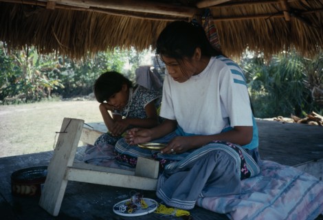USA, Florida, Everglades, Independent Seminole Native American children making bead necklaces