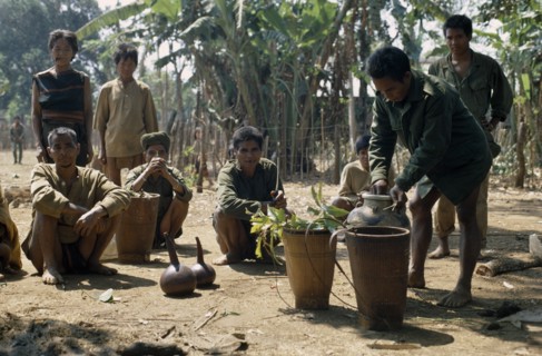 VIETNAM, Central Highlands, Pleimurong village, "Vietnam War. Montagnard village soldiers filling