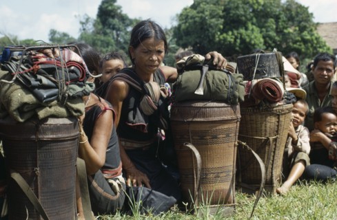 VIETNAM, Central Highlands, Kontum, Vietnam War. Montagnard refugee families waiting to be shipped