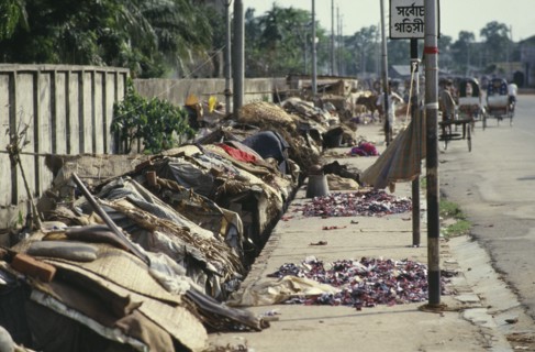 BANGLADESH, Dhaka, Roadside slum dwellings along pavement in city centre.