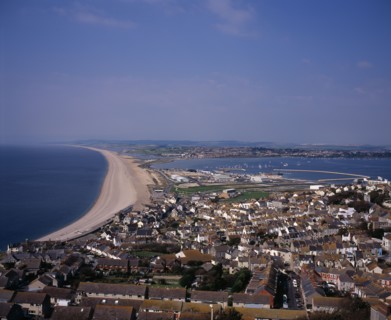 ENGLAND, Dorset, Portland, Elevated view over Chesil Beach from cliff path above town of