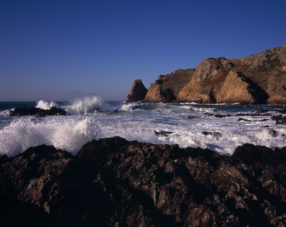 UNITED KINGDOM, Channel Islands, Jersey, St Ouen. Le Pulec. Rough sea and waves crashing against